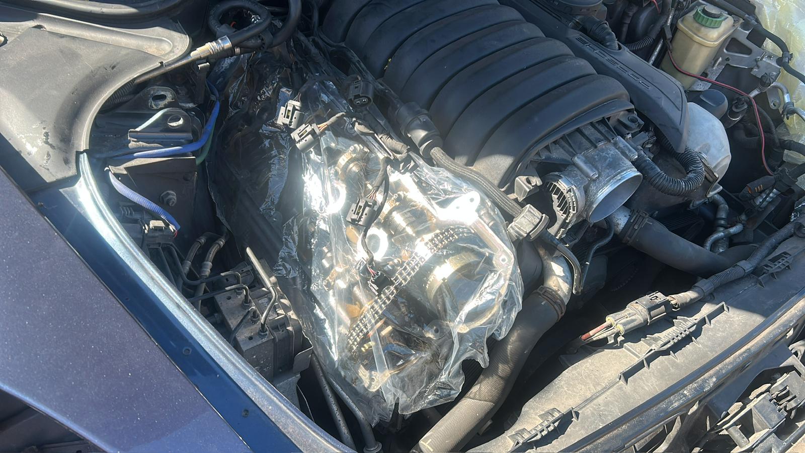 Open engine bay showing intake and mechanical systems